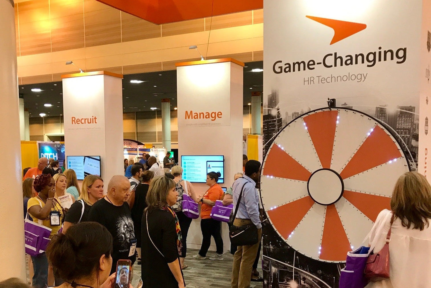 Exhibition booth with 'Game-Changing HR Technology' branding at a convention.